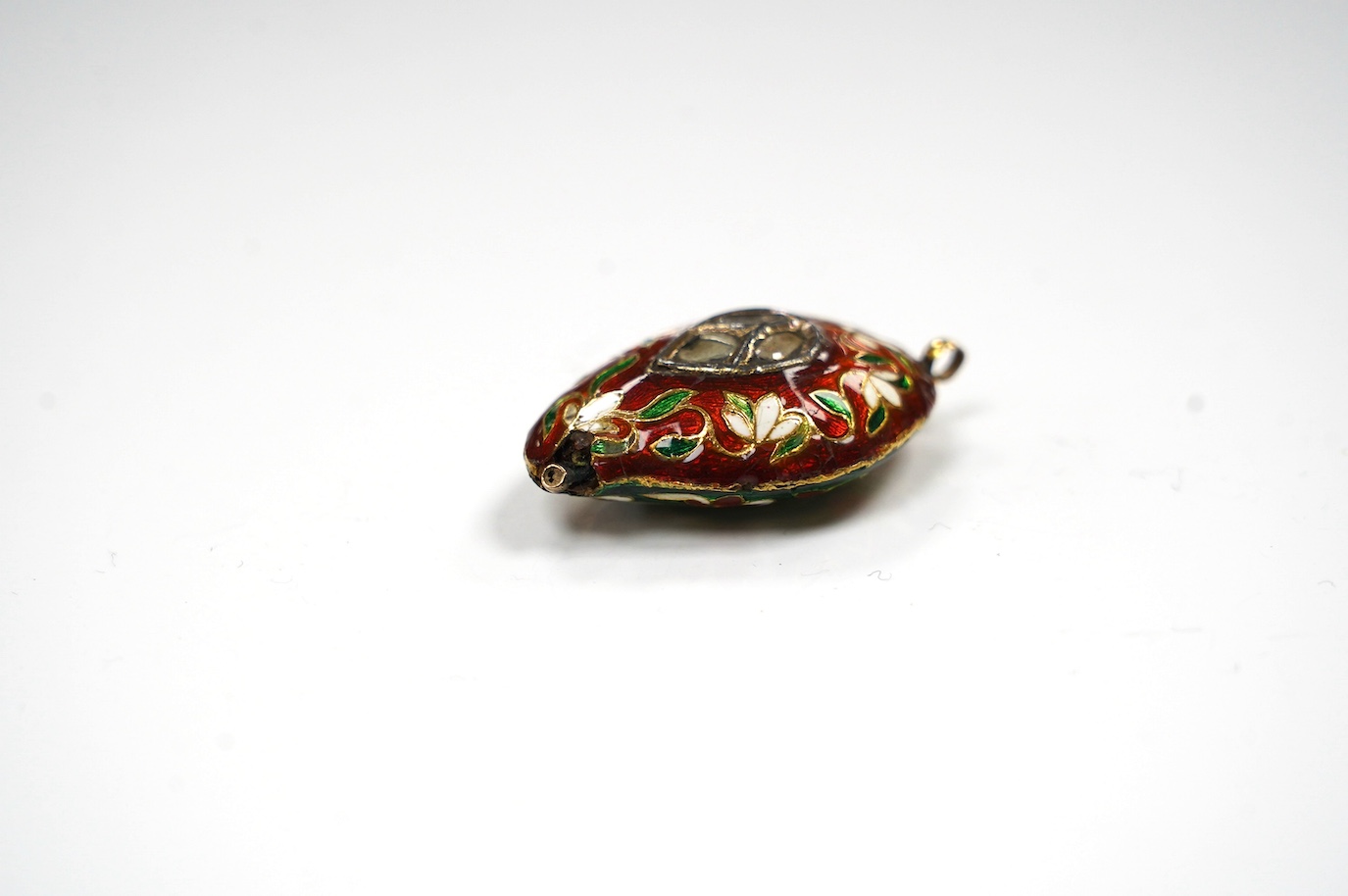 An Indian enamel and flat cut diamond set pear shaped pendant, 40mm. Condition - poor